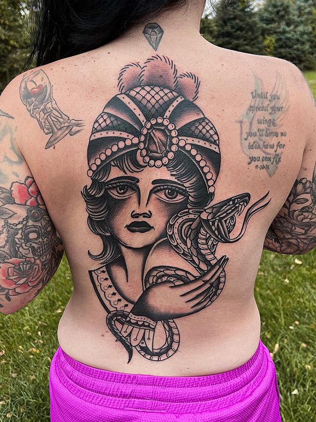 Black and grey back tattoo of a lady with a serpent by Penny Boy — black-and-grey realism back piece art