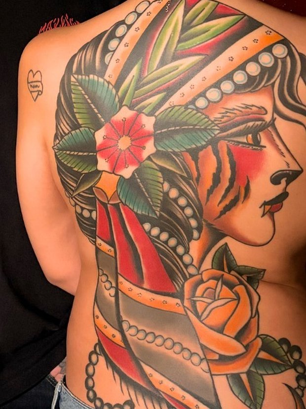 Full back tattoo of a gypsy woman with pearl headscarf and tiger-stripe face by Penny Boy — neo-traditional colour back piece