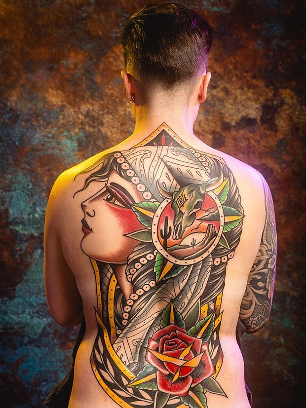 Neo-traditional back piece of a woman with an hourglass by Penny Boy — large-scale colour full back tattoo