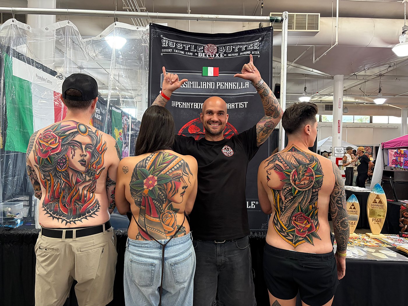 Penny Boy convention booth with award-winning back pieces